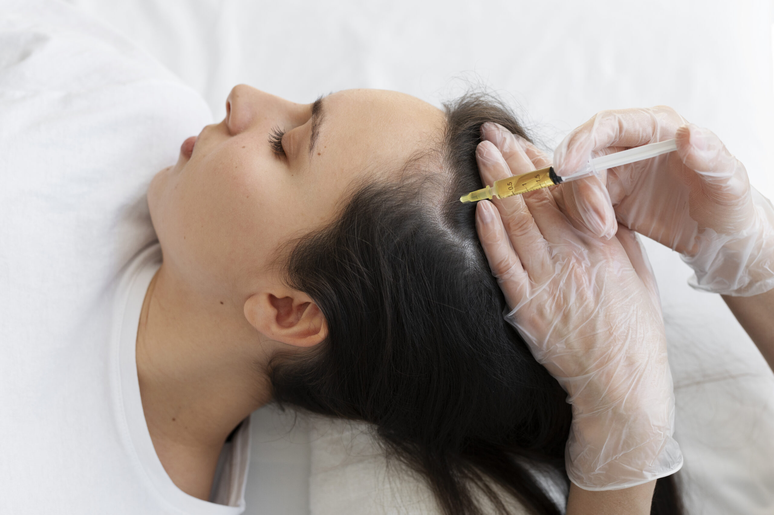 A dermatologist in Mumbai performing PRP treatment for hair loss, highlighting the clinical setting and patient care.